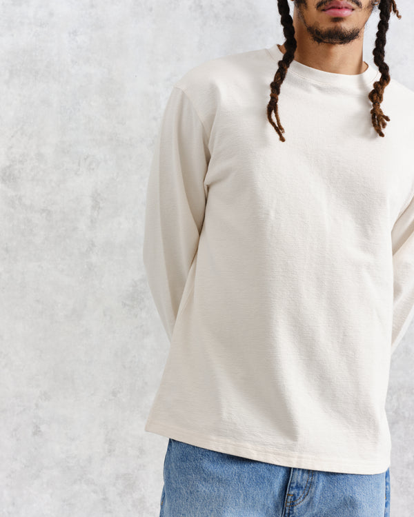 model facing front wearing wax london white textured organic cotton long sleeve t-shirt