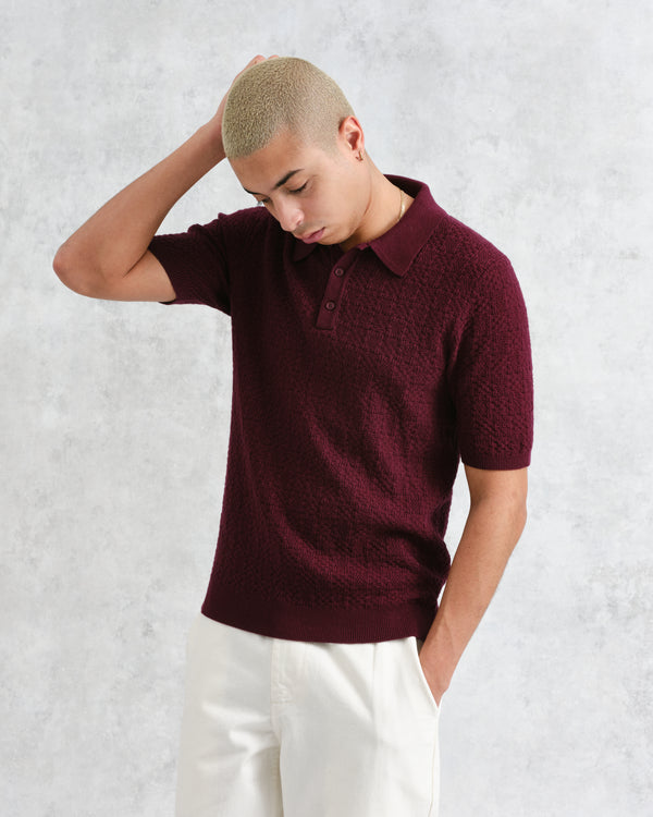 model facing front wearing wax london burgundy textured check knitted polo shirt