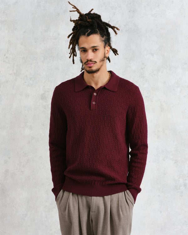 model facing front wearing wax london burgundy textured check knitted long sleeve polo shirt