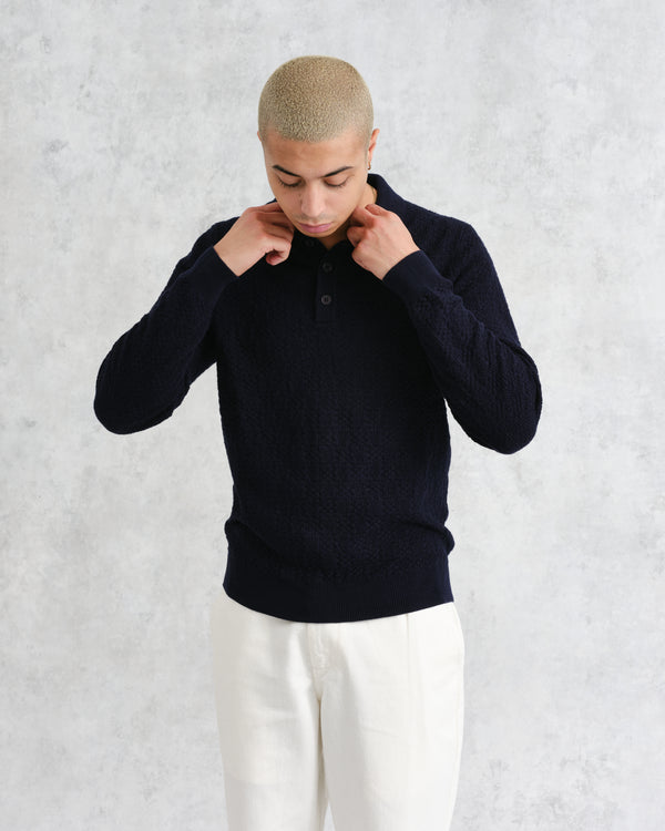 model facing front wearing wax london navy textured check knitted long sleeve polo shirt